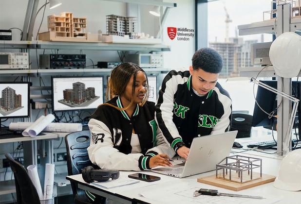 Two architecture and construction students working on a project.