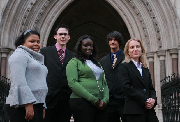 Students smiling in front of a building