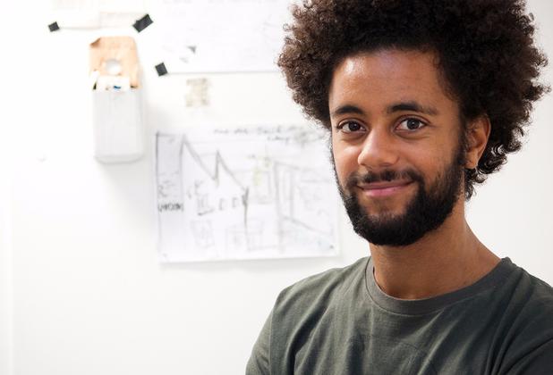 Mixed race student by art board