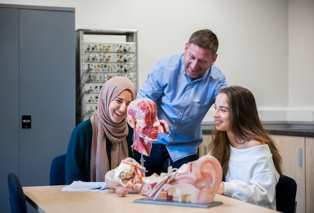 Students looking at a brain sculpture