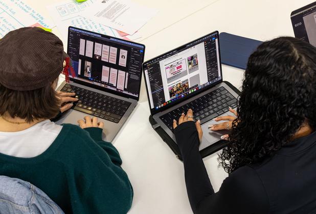 Two students creating content on their laptops