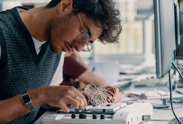 Computer science student working on a pcb