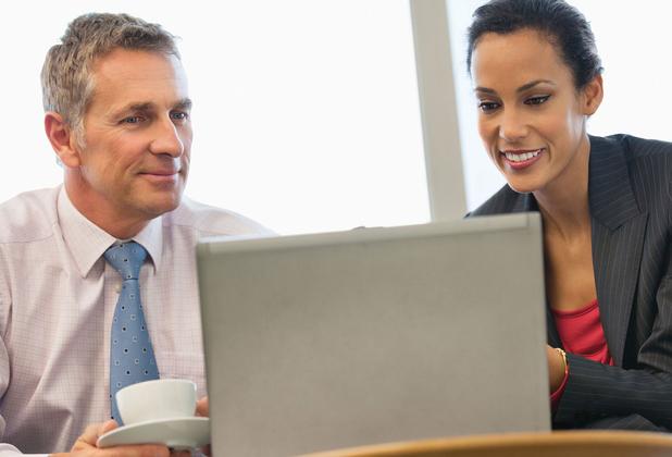 two professional colleagues looking at a computer screen