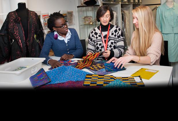 Two women examining fabrics