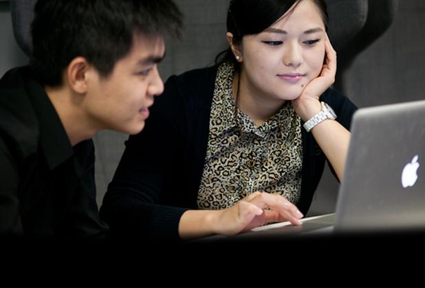 Two students on a laptop