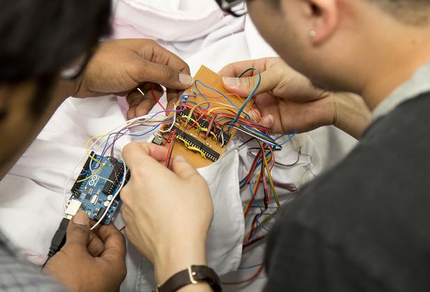 Students holding robotic equipment
