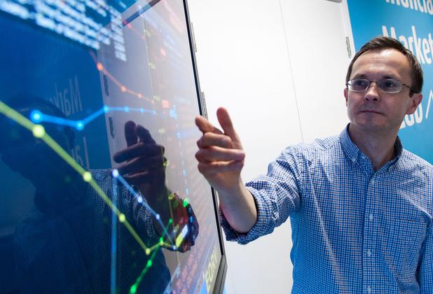 A lecturer pointing at a screen