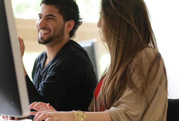male and female student smiling
