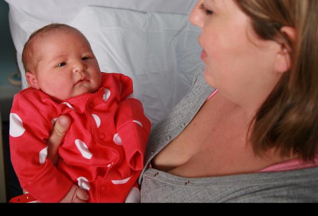 A woman holding a baby