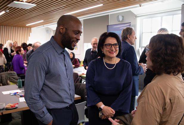 Adults having a friendly chat in a busy room