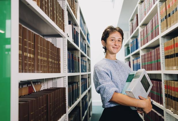 female middlesex university student in the sheppard library carrying books