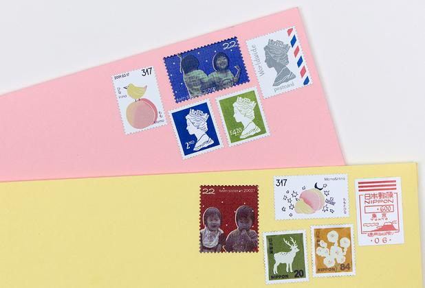 Two envelopes, one pink and one yellow with stamps