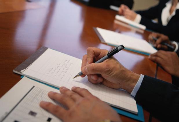 A student writing on a notepad