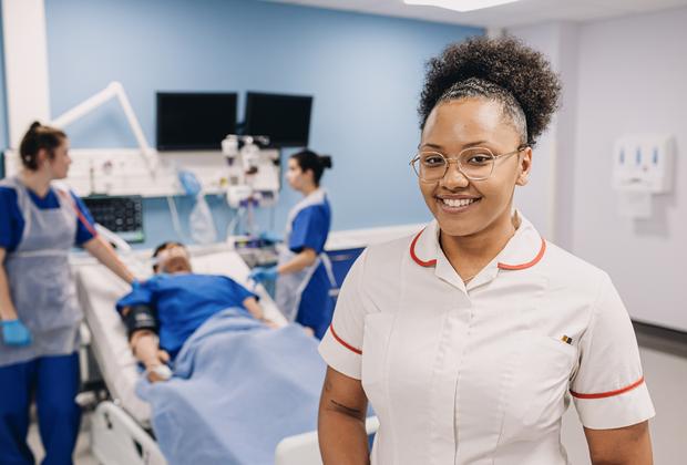 Healthcare students take part in a patient care simulation in a university clinical training environment