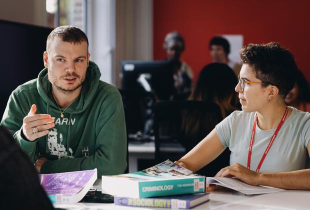 Criminology students discuss course materials and social issues during a seminar session