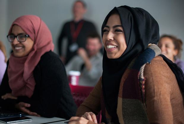 Students smiling in class, listening