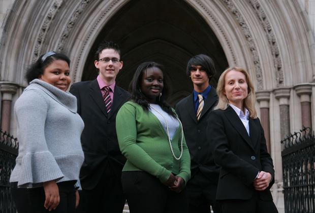Students smiling in front of a building