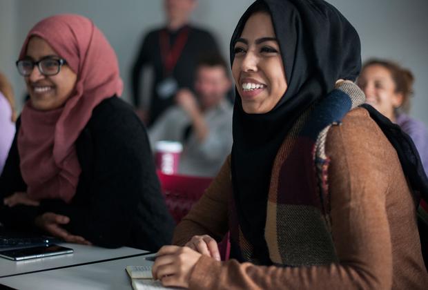 Female students wearing hijabs attending an education studies class