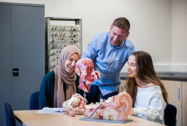 Students looking at a brain sculpture