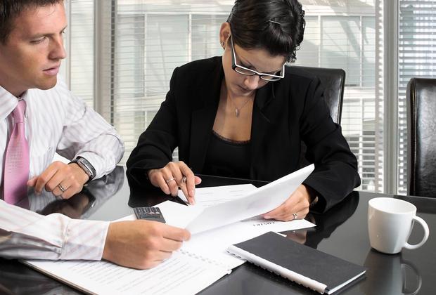 Business-like students reading documents
