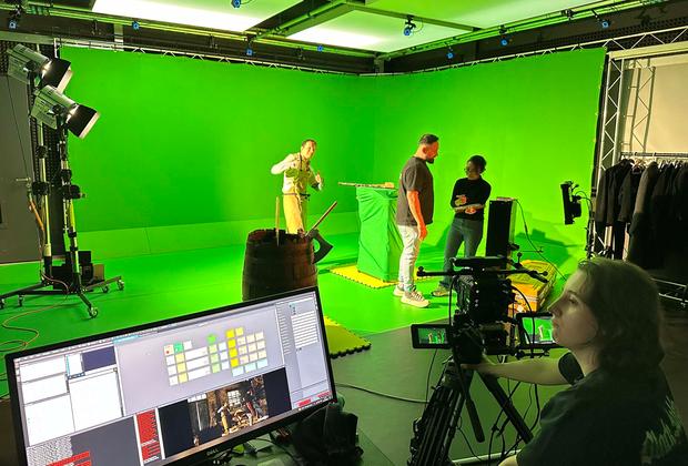 Students filming using green screen technology