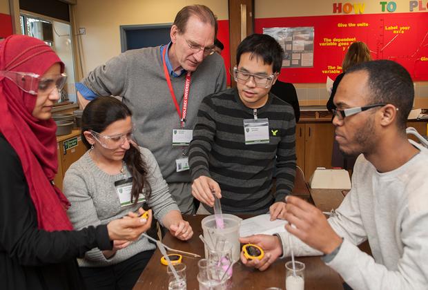 A lecturer and students in a lab