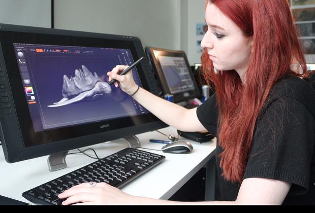 Student using  pen and 3D animation software on screen