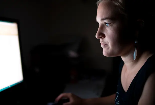 woman reading something from a computer screen