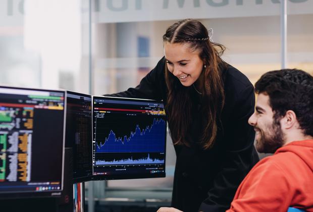 Student and teacher looking at graphics onto a computer monitor