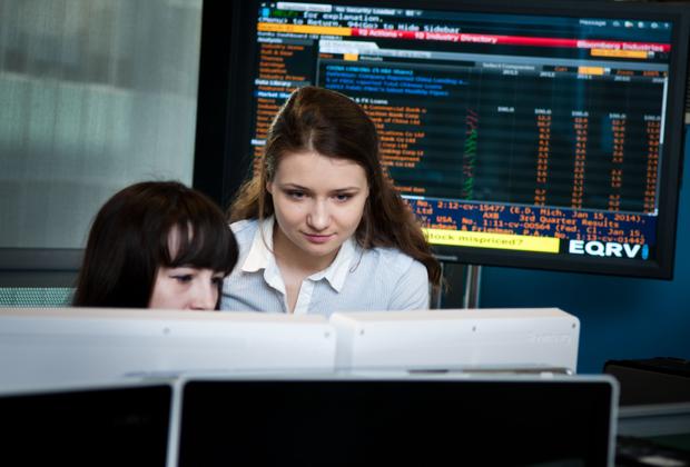 Two students working on a computer at the Financial Markets Lab