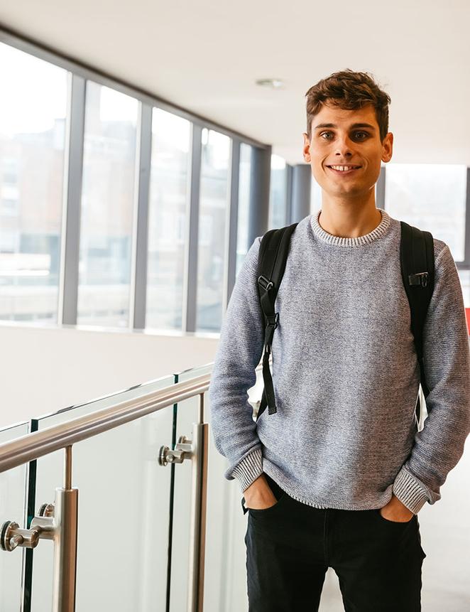 student standing in modern building
