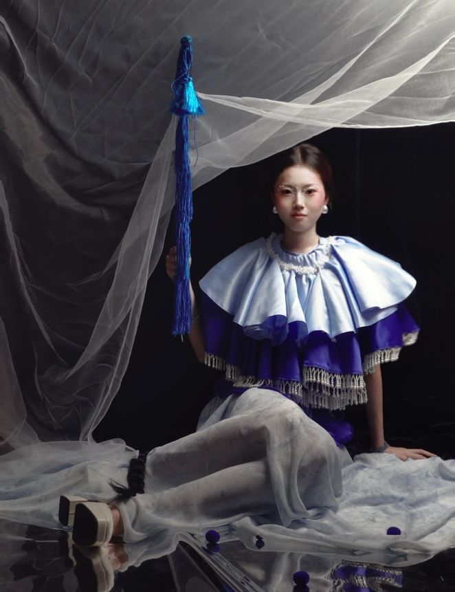 A work by Liang Jiayan showing a model wearing porcelain blue against a grey background