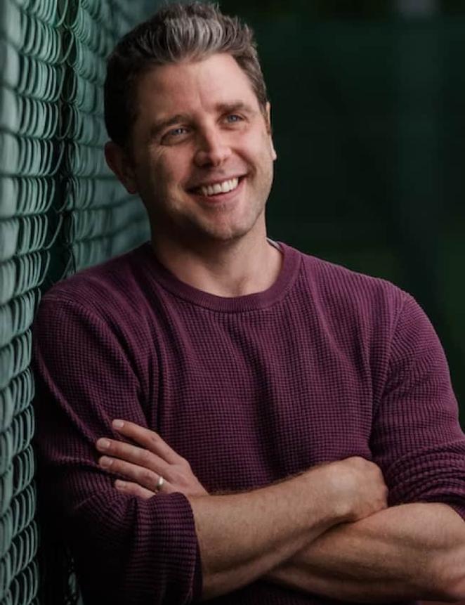 Person smiling with arms folded