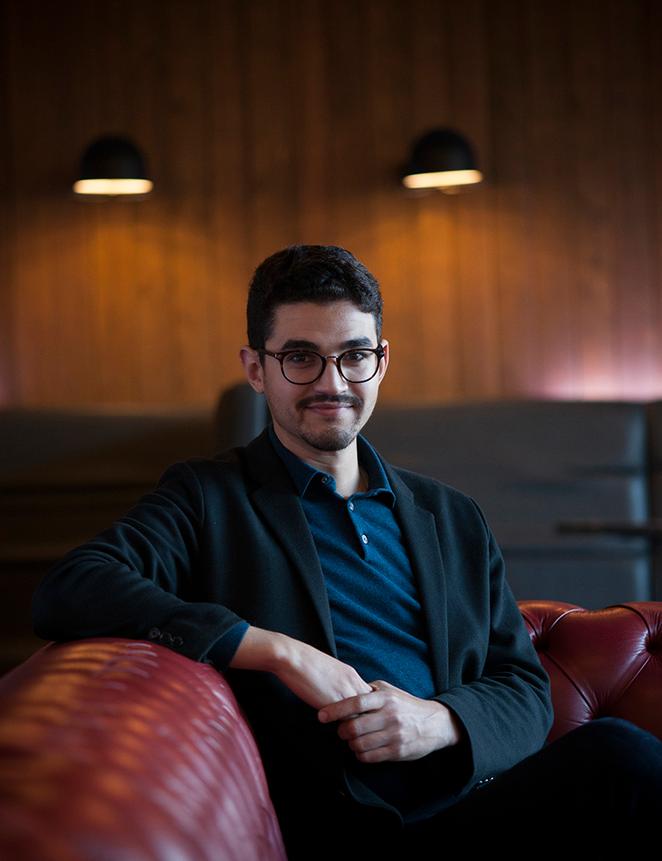 Student in glasses sits on chair
