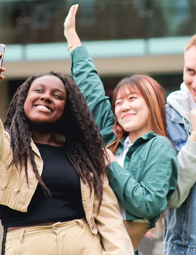 Three students on campus taking a selfie