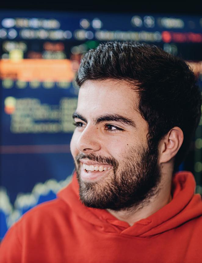 smiling student in front of financial information