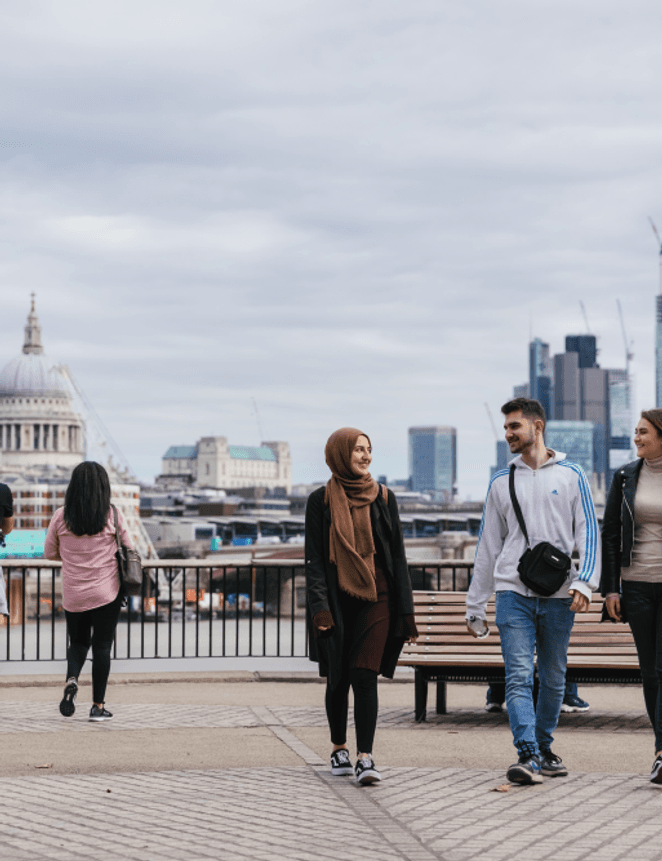 Students walking by the River, with St Pauls Cathedral and London Cityscape in the background