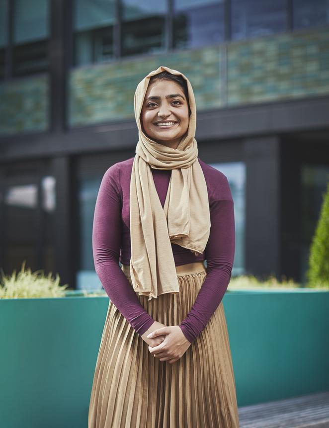 Student standing outside a university building.