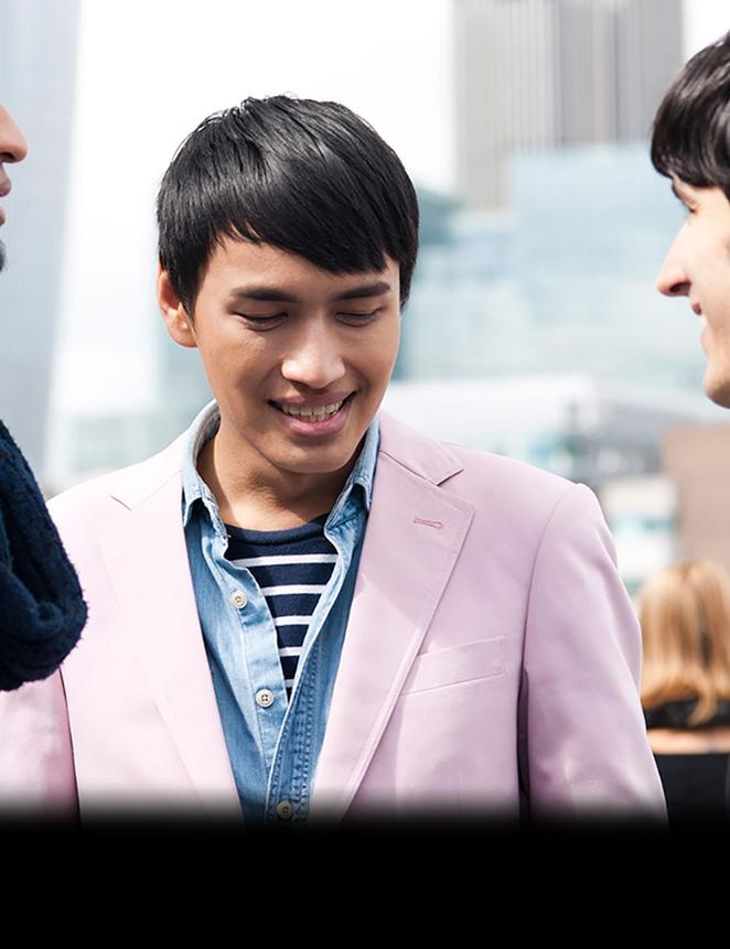 three students facing each other smiling