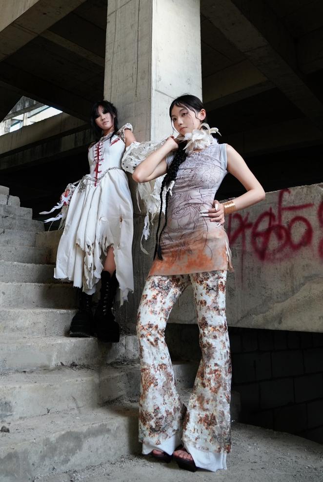 A design by Lin Wan Yi and Hu Ya Bing showing two women in front of a pillar with graffiti nearby