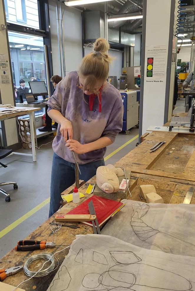 Student in workshop making film props