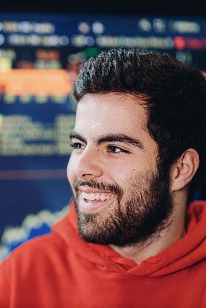 smiling student in front of financial information
