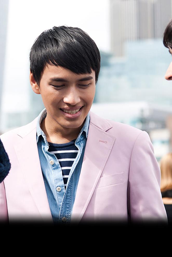 three students facing each other smiling