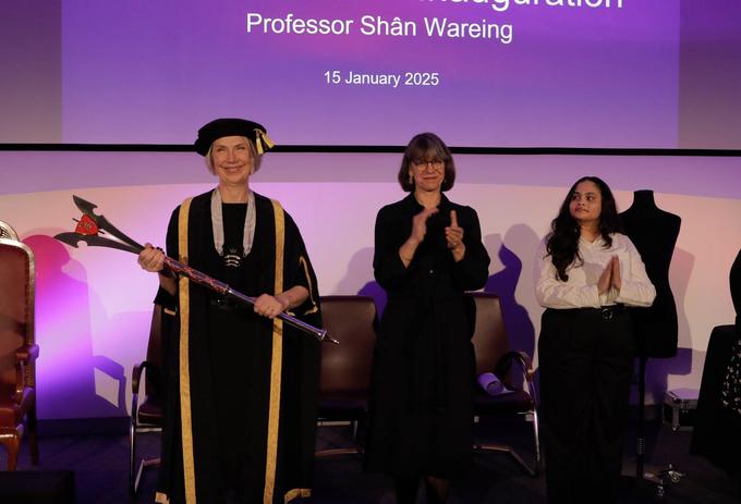 Middlesex University VC celebrating her inauguration alongside a group of people