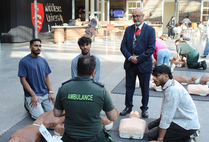 Deputy Mayor of Barnet, Humayune Khalick watches a CPR training session.