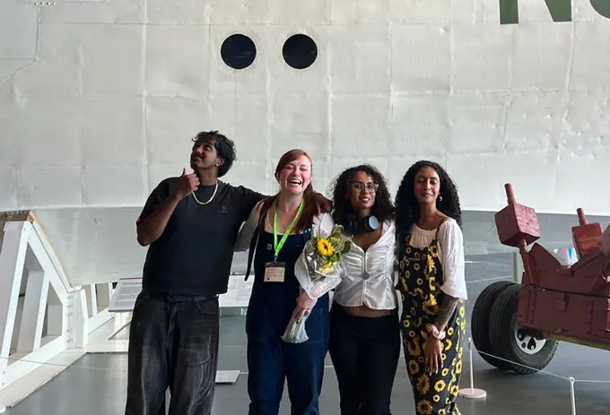 Four ̽������ University Graphic Design and Illustration students standing together in front of an exhibition at the RAF Museum.