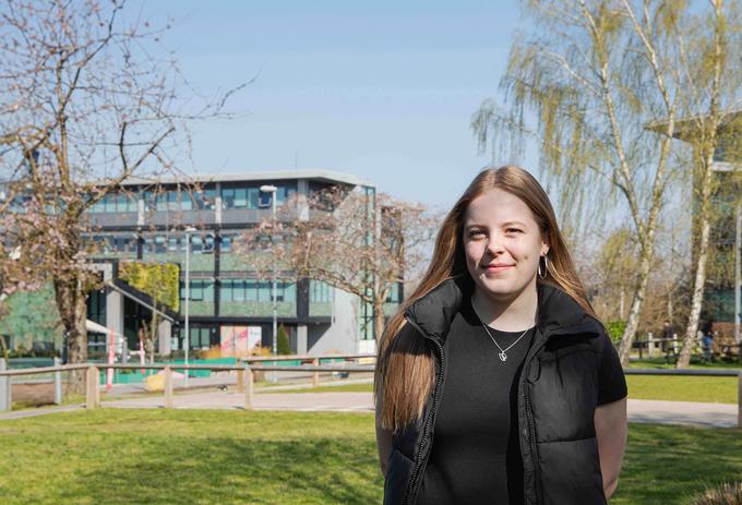 Student Abbi stood on campus on a sunny day