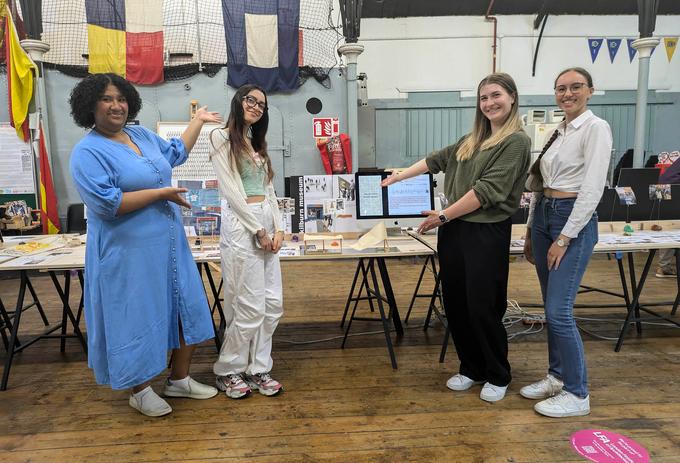 Some of the students involved in the project with part of the exhibition