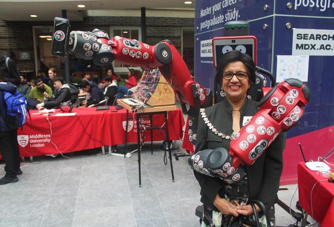A lady posing with a Robot- Mdx Stem fest