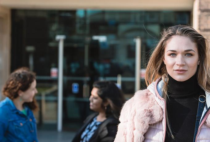 Female student stood outside campus